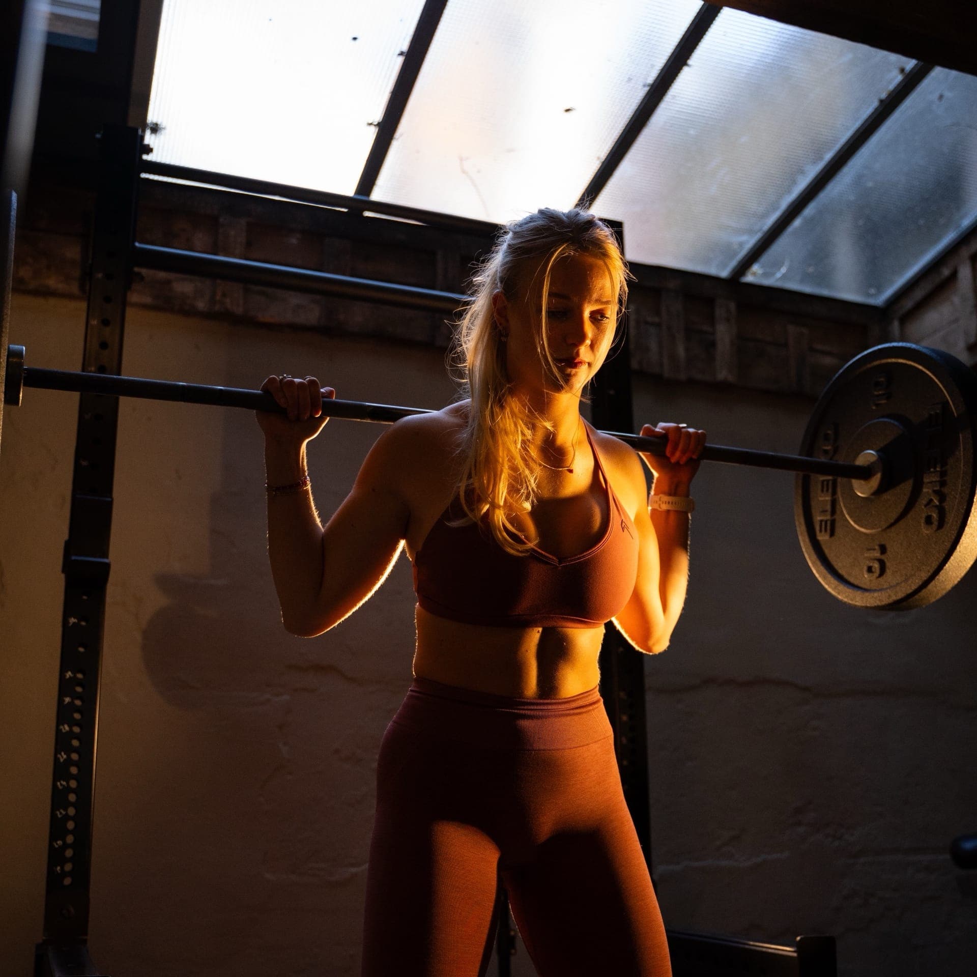 Barbell squat in Rogue rack at SculptClub