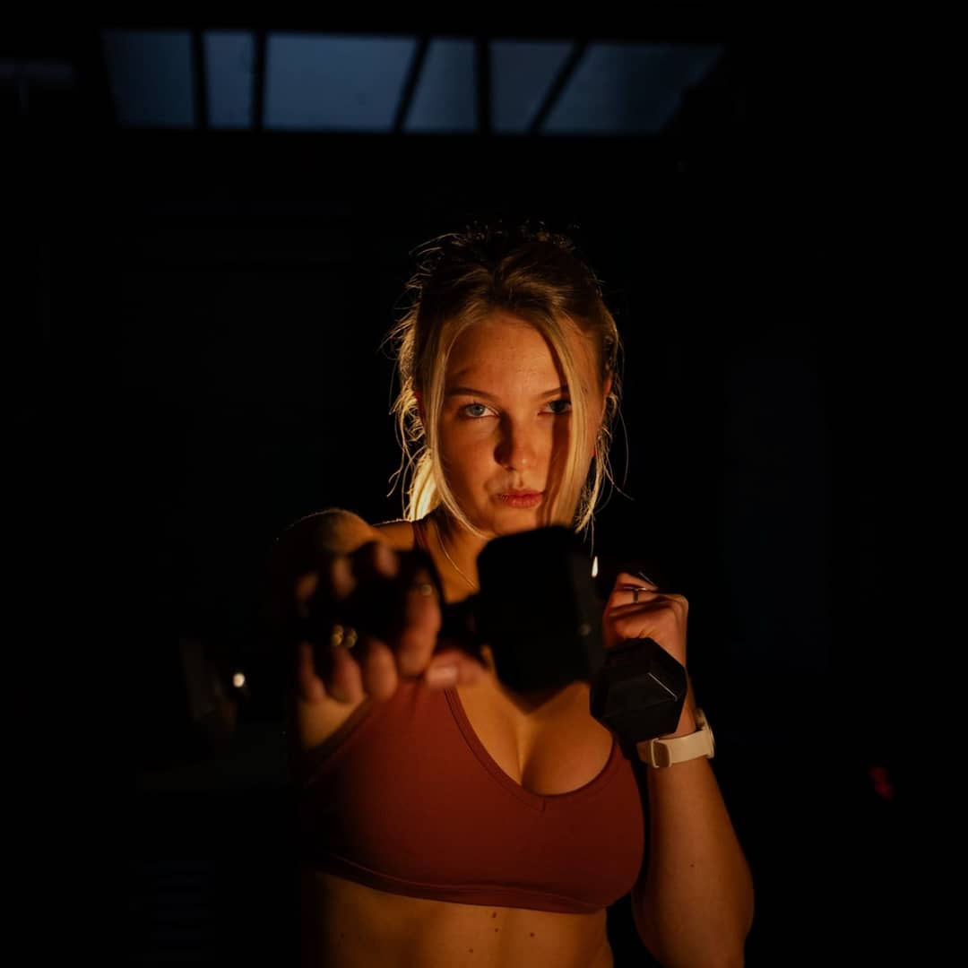 A woman training with dumbbells in the SculptClub studio