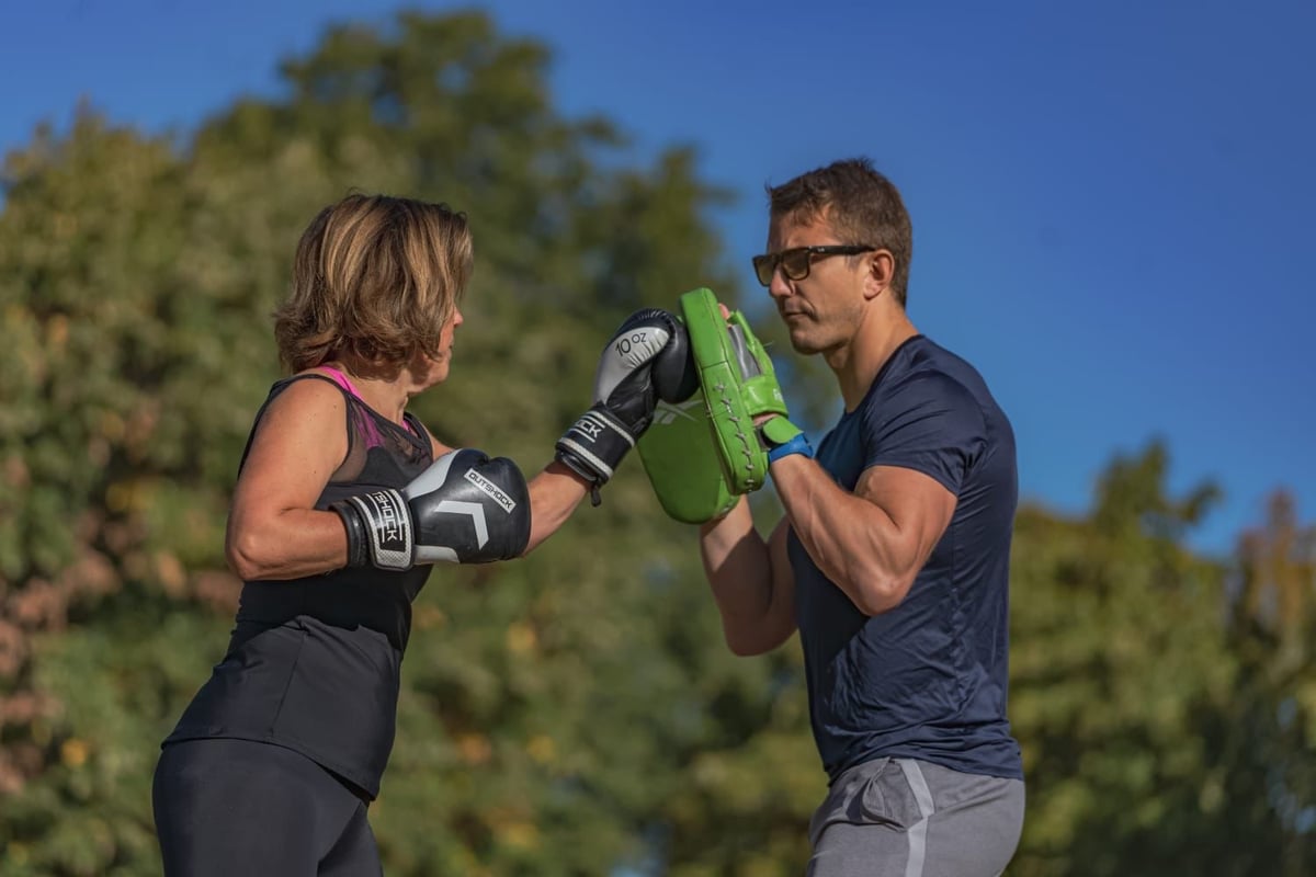 Tom coaching a client with focus mitts